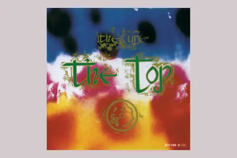 Copertina psichedelica dell'album di The Cure "The Top", con colori vivaci e testo verde.