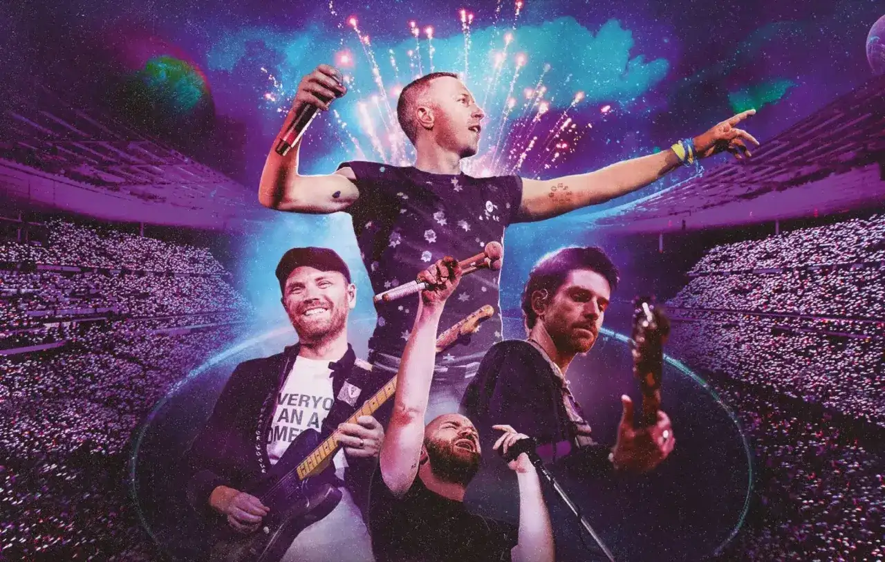 I Coldplay in concerto, un'esplosione di musica e luci in uno stadio gremito.