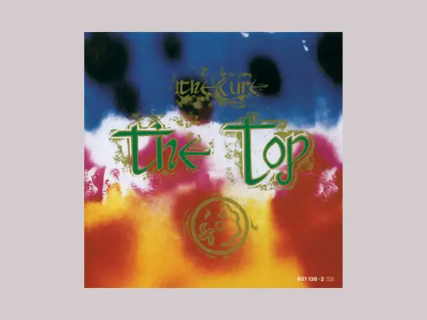 Copertina psichedelica dell'album di The Cure "The Top", con colori vivaci e testo verde.